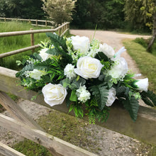 Top table flower arrangement featuring white or ivory roses