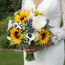 A wedding bouquet featuring calla lilies, roses & sunflowers