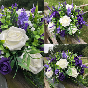 An artificial flower table centre in shades of ivory lilac & purple