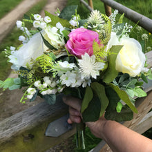 A wedding bouquet featuring ivory & Violet silk roses