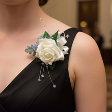 An artificial wedding buttonhole featuring an ivory rose & blue forgetmenots