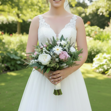 A wedding bouquet featuring dusky pink gerbera and roses