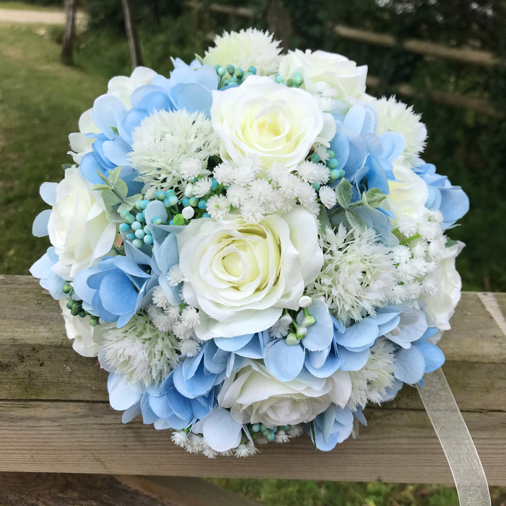 A brides bouquet of white/ivory and pale blue artificial silk flowers ...