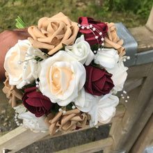 A wedding bouquet of champagne, ivory, burgundy & coffee foam roses