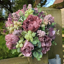 a wedding bouquet collection of pink and mauve flowers