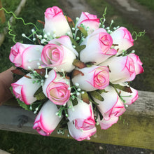 A bridal bouquet of artificial pink edged roses