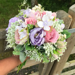 a wedding bouquet of artificial silk ivory hydrangea and lilac rose flowers