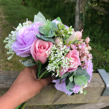 a wedding bouquet of artificial silk ivory hydrangea and lilac rose flowers