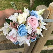 brides wedding bouquet of artificial ivory,blue and pink rose flowers with diamantes
