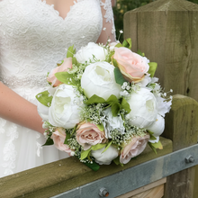 a wedding bouquet of artificial blush roses and peonies