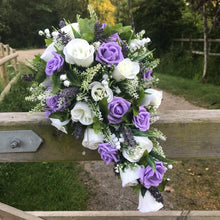 A teardrop bouquet collection of ivory and lilac artificial roses