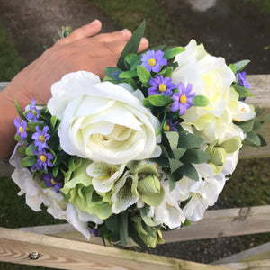 a wedding bouquet of artificial silk ivory, green & purple flowers