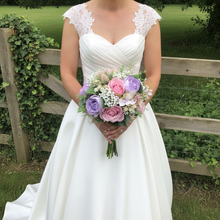 a wedding bouquet of artificial silk ivory hydrangea and lilac rose flowers