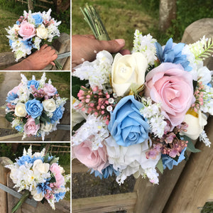 brides wedding bouquet of artificial ivory,blue and pink rose flowers with diamantes