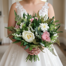 A wedding bouquet featuring dusky pink gerbera and roses