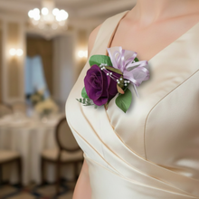 A purple faux silk rose buttonhole with pearls and lilac ribbon