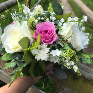 A wedding bouquet featuring ivory & Violet silk roses