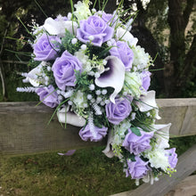 A wedding bouquet collection of lilac roses & calla lilies