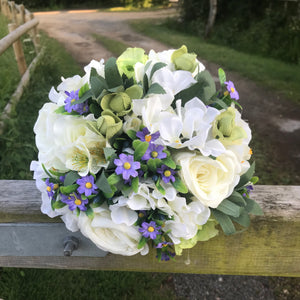 a wedding bouquet of artificial silk ivory, green & purple flowers