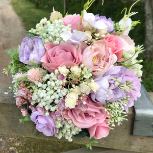 a wedding bouquet of artificial silk ivory hydrangea and lilac rose flowers