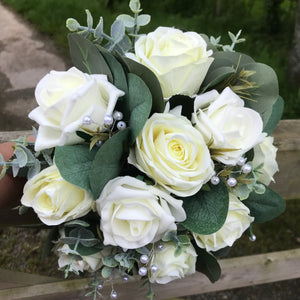 A teardrop wedding bouquet collection of artificial ivory roses