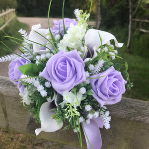 A wedding bouquet collection of lilac roses & calla lilies