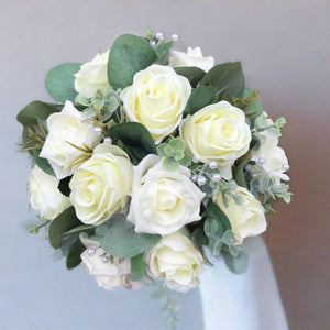 A teardrop wedding bouquet collection of artificial ivory roses