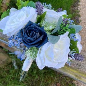 A wedding bouquet of navy blue and ivory flowers