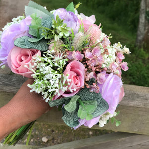a wedding bouquet of artificial silk ivory hydrangea and lilac rose flowers
