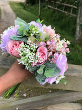 a wedding bouquet of artificial silk ivory hydrangea and lilac rose flowers