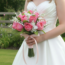 a brides wedding bouquet of artificial roses & lily of the valley
