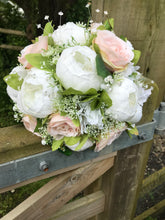 a wedding bouquet collection of artificial blush roses and peonies