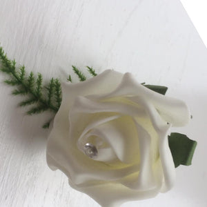 a pack of 6 ivory foam rose buttonholes with asparagus fern