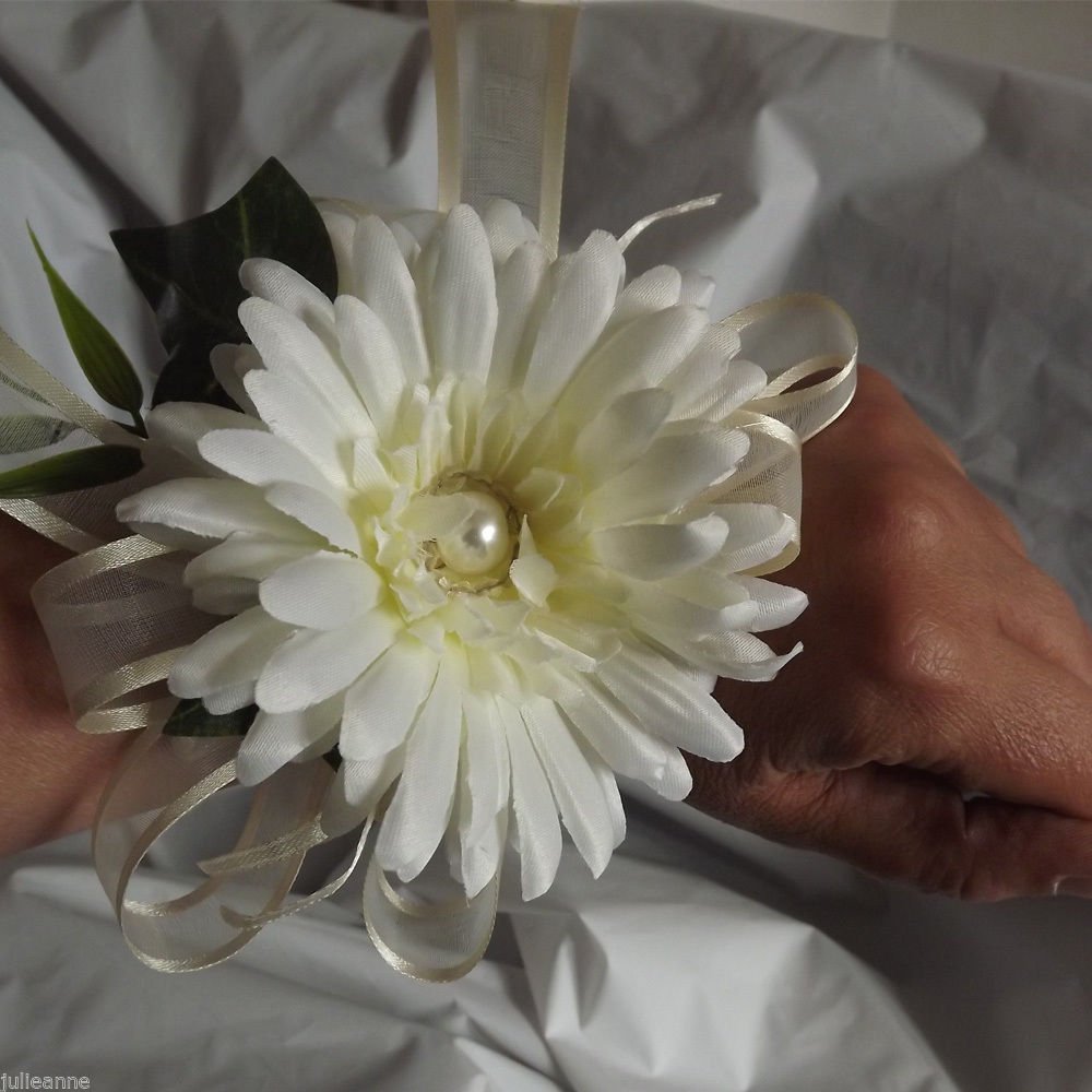 WRIST CORSAGE - an ivory artificial silk gerbera with ribbon bow & foliage