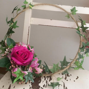 a rustic flower hoop featuring artificial silk roses & ivy