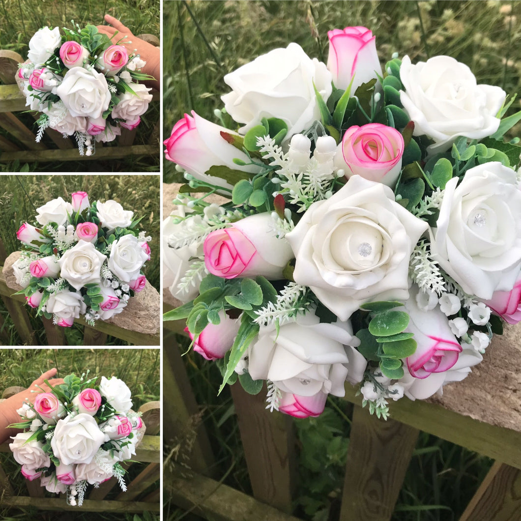 An artificial wedding bouquet featuring pink and white roses