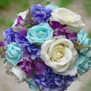 wedding bouquet of artificial ivory blue roses and hydrangea flowers