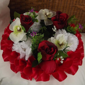 memorial wreath of artificial silk roses and orchids in shades of red