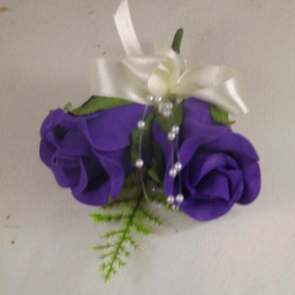 wedding buttonhole features two purple foam roses