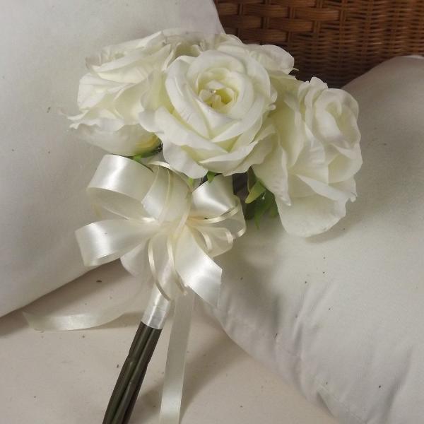 a wedding posy featuring large ivory open roses