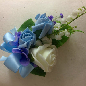 an artificial corsage in shades of blue and ivory