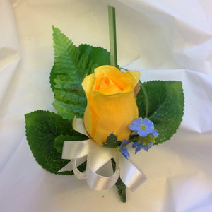 a yellow silk rose bud buttonhole