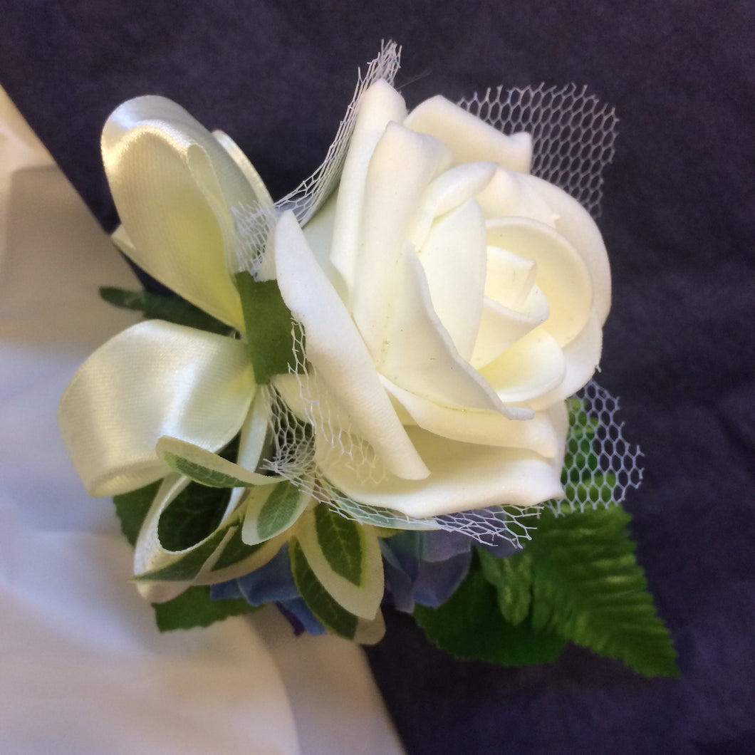 a buttonhole of ivory foam rose with netting