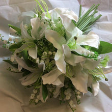 a wedding bouquet of artificial lilies and lily of the valley flowers
