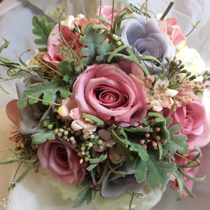 a brides wedding bouquet in shades of lilac/grey & pink artificial flowers