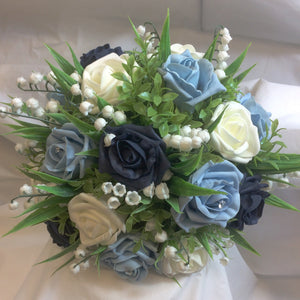 brides bouquet featuring roam roses and lily of the valley