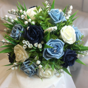 blue foam roses and lily of the valley feature in this wedding bouquet