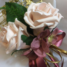 a bridesmaids gold metal heart shaped wand with mocha pink roses