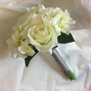 A wedding bouquet collection of artificial silk ivory flowers