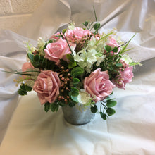 A flower arrangement featuring foam roses